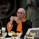 Pope Francis administers the unholy sacrament to parishioners in the Haunted House of the Lord.